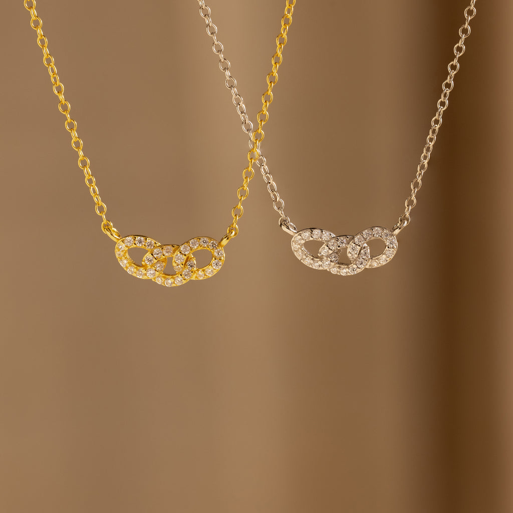 The Pave Link Necklace, available in gold and silver, features interlocking links and a diamond-studded circle pendant—an ideal addition to any jewelry collection.