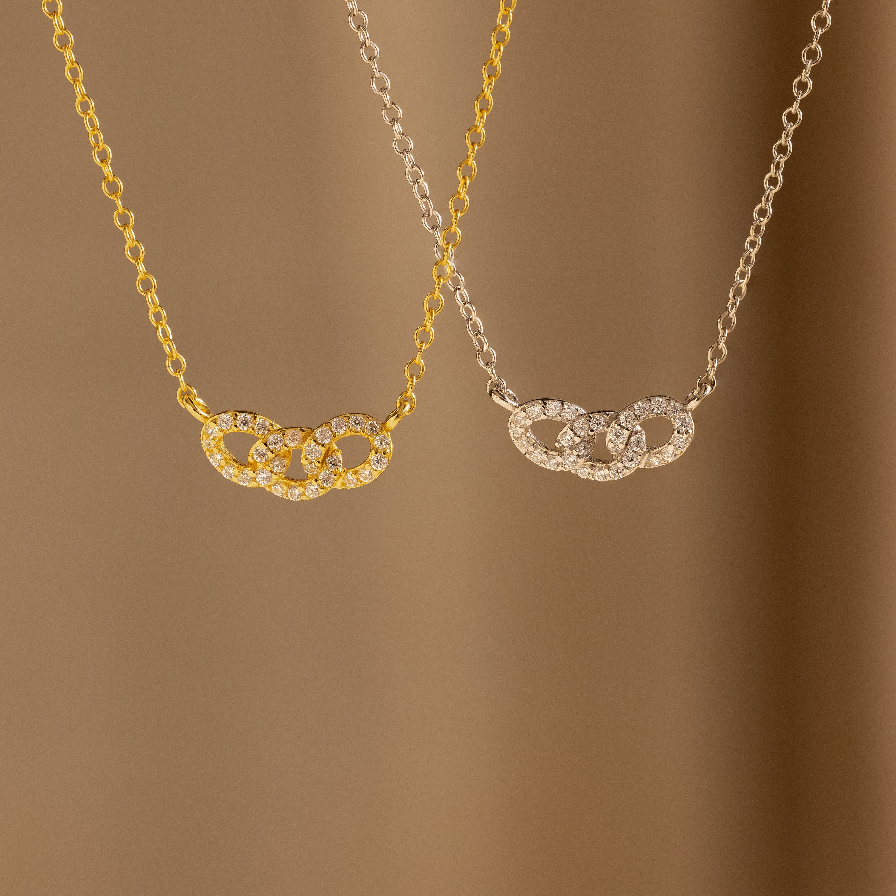 The Pave Link Necklace, available in gold and silver, features interlocking links and a diamond-studded circle pendant—an ideal addition to any jewelry collection.