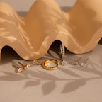 A group of jewelry, including the Diamond Drop Earrings Set, arranged elegantly on a table.