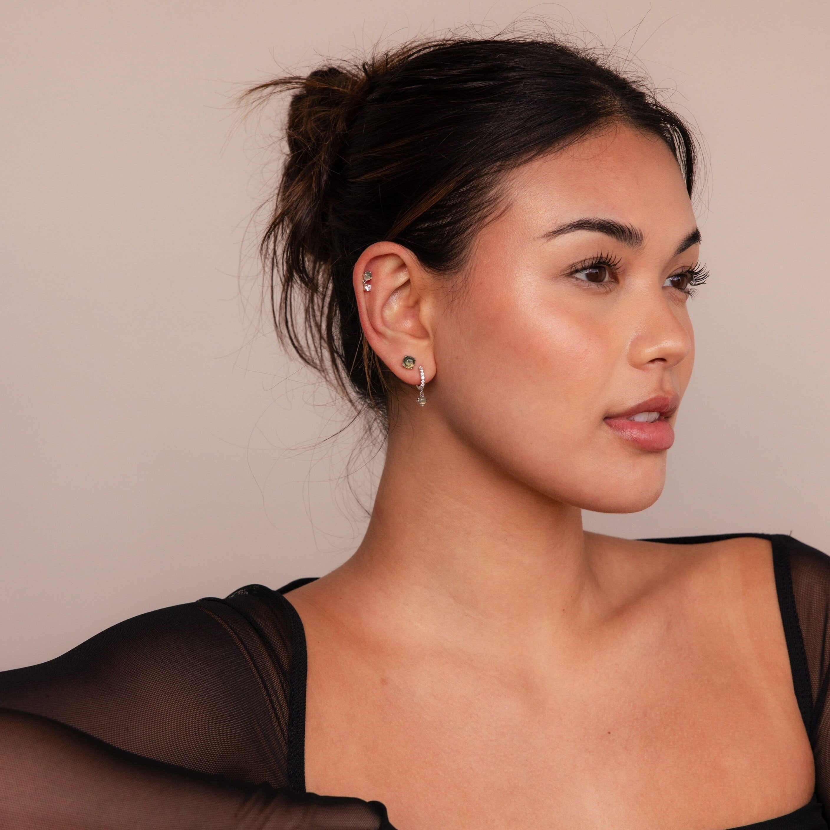 Woman wearing the Agate Earrings Set and a sheer black top, looking to the side with a neutral expression against a plain background.