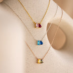 The Toi et Moi Birthstone Necklace is shown in gold, silver, and rose gold on a cream bust—ideal for personalizing your own birthstone or gemstone jewelry look.