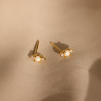 Opal and Diamond Studs, ideal for cartilage or helix piercings, are displayed on light beige satin fabric.