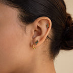 Close-up of a woman's ear with the Agate Cartilage Earrings Set—three gold earrings including a hoop and two green gemstone studs, ideal for unique cartilage piercings or as a meaningful gift for best friends.