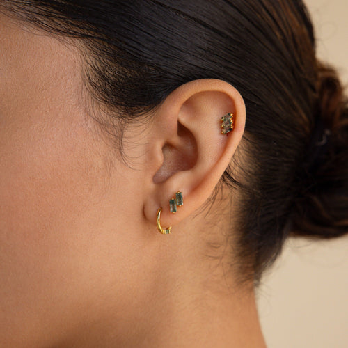 Close-up of a woman's ear with the Agate Cartilage Earrings Set—three gold earrings including a hoop and two green gemstone studs, ideal for unique cartilage piercings or as a meaningful gift for best friends.