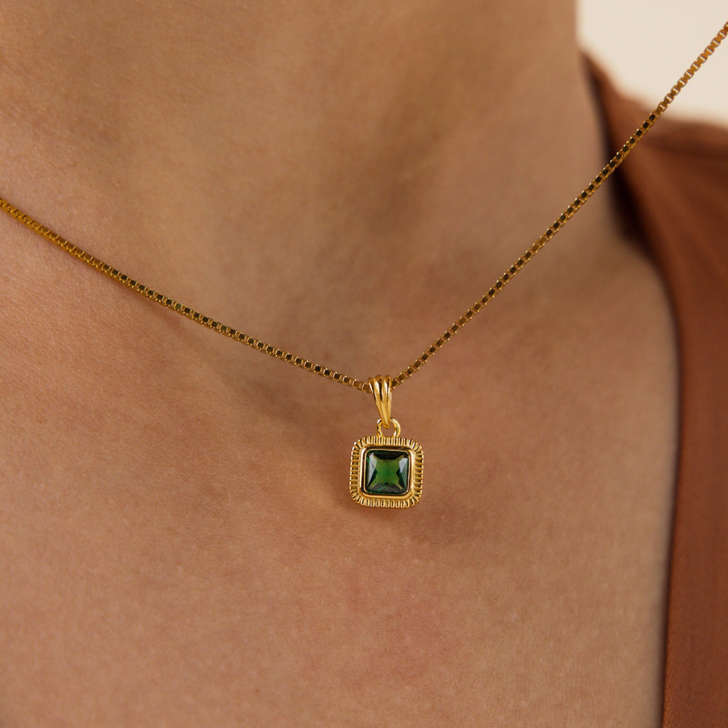 The Vintage Emerald Pendant Necklace features a square-cut emerald gemstone in an Art Deco-inspired pendant, adding vintage elegance to your neckline.