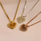The Pave Fingerprint Heart Necklace comes in gold, silver, and rose gold with a personalized engraved fingerprint heart pendant and sparkling gem accents.