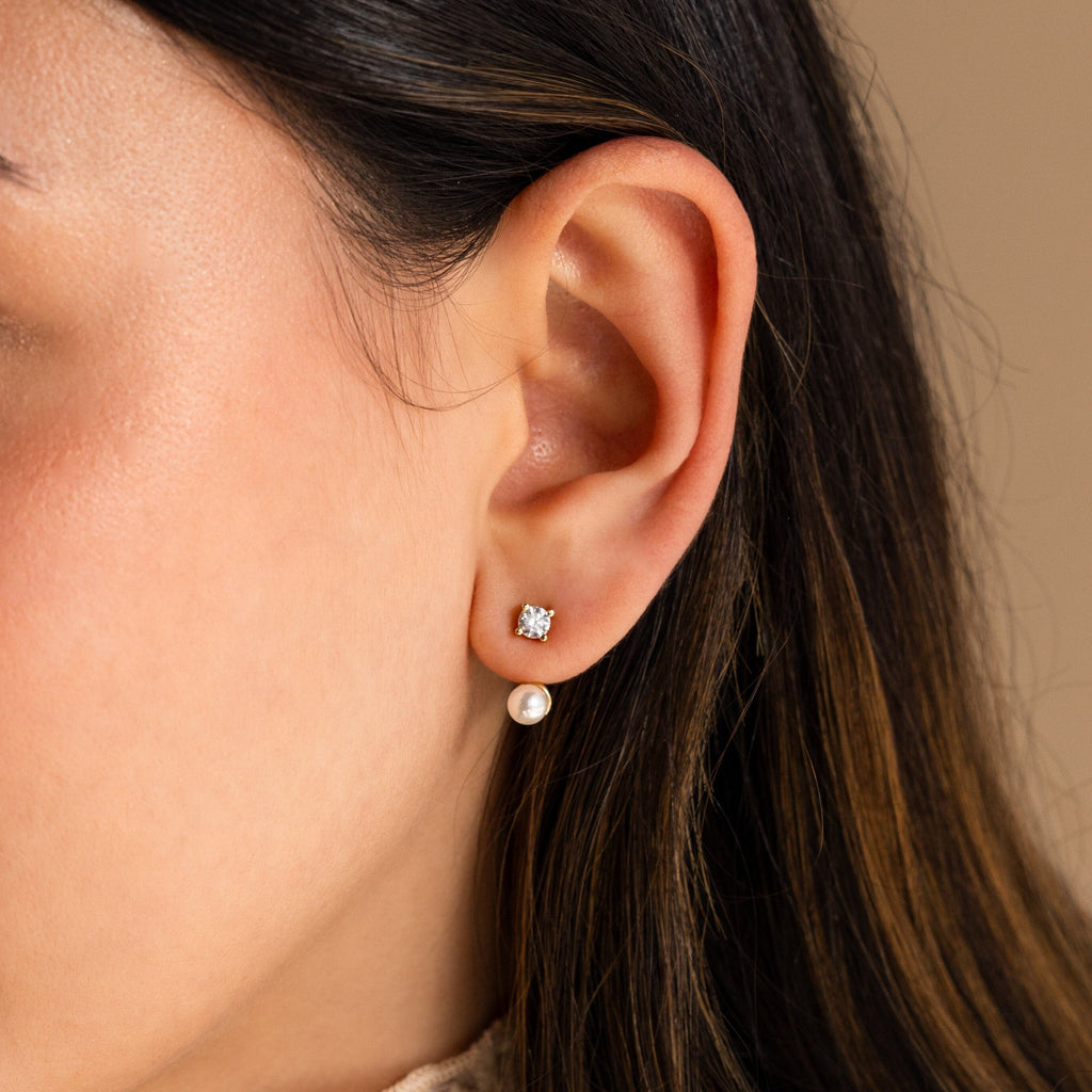 Close-up of a woman's ear adorned with Diamond Pearl Ear Jackets, featuring a sparkling stud and elegant pearl drop—ideal for minimalist jewelry enthusiasts.