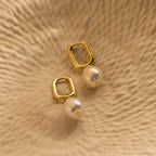 Elevate your style with our Freshwater Pearl Drop Hoops—gold hoops adorned with dangling white pearls, perfect for adding timeless elegance to any outfit.