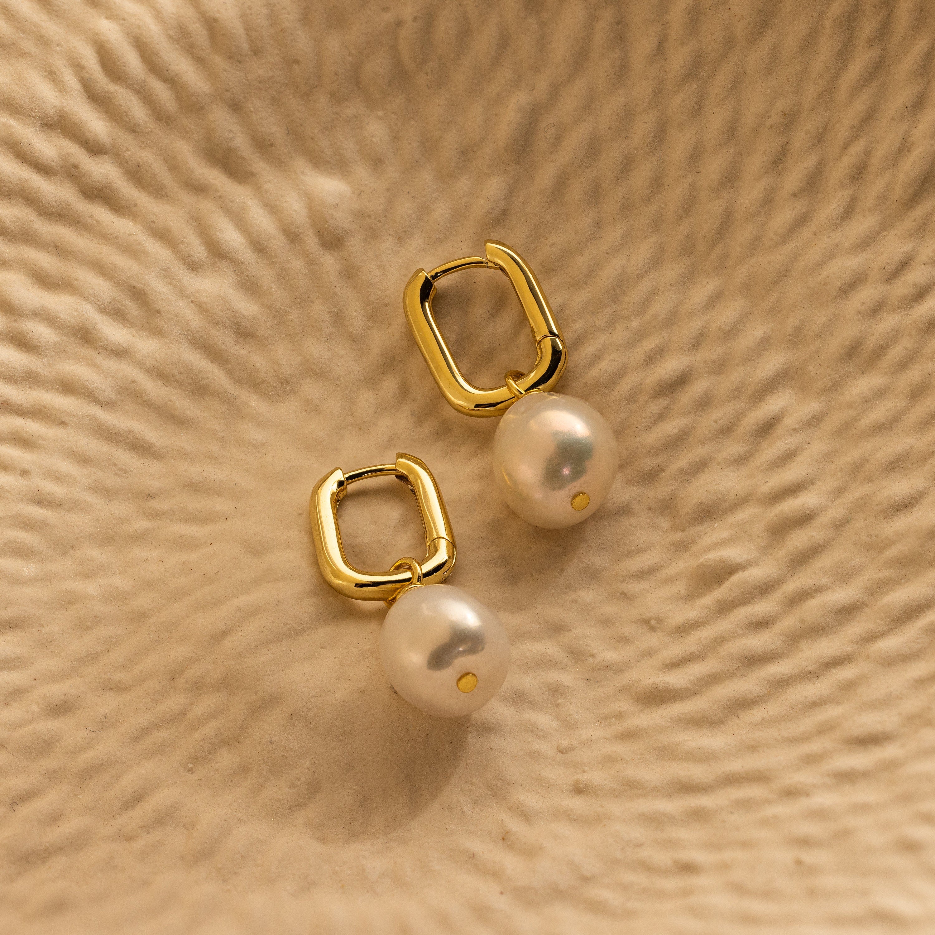 Elevate your style with our Freshwater Pearl Drop Hoops—gold hoops adorned with dangling white pearls, perfect for adding timeless elegance to any outfit.