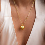The Diamond Ribbed Heart Necklace, paired with a white v-neck top, adds vintage-inspired charm and elegance to your look.