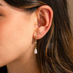 A close-up of a woman's ear wearing Diamond Pearl Chain Earrings.