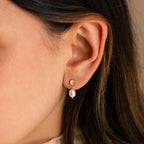 Close-up of a woman's ear wearing Moonstone Pearl Drop Earrings, a timeless and elegant addition to any jewelry collection.