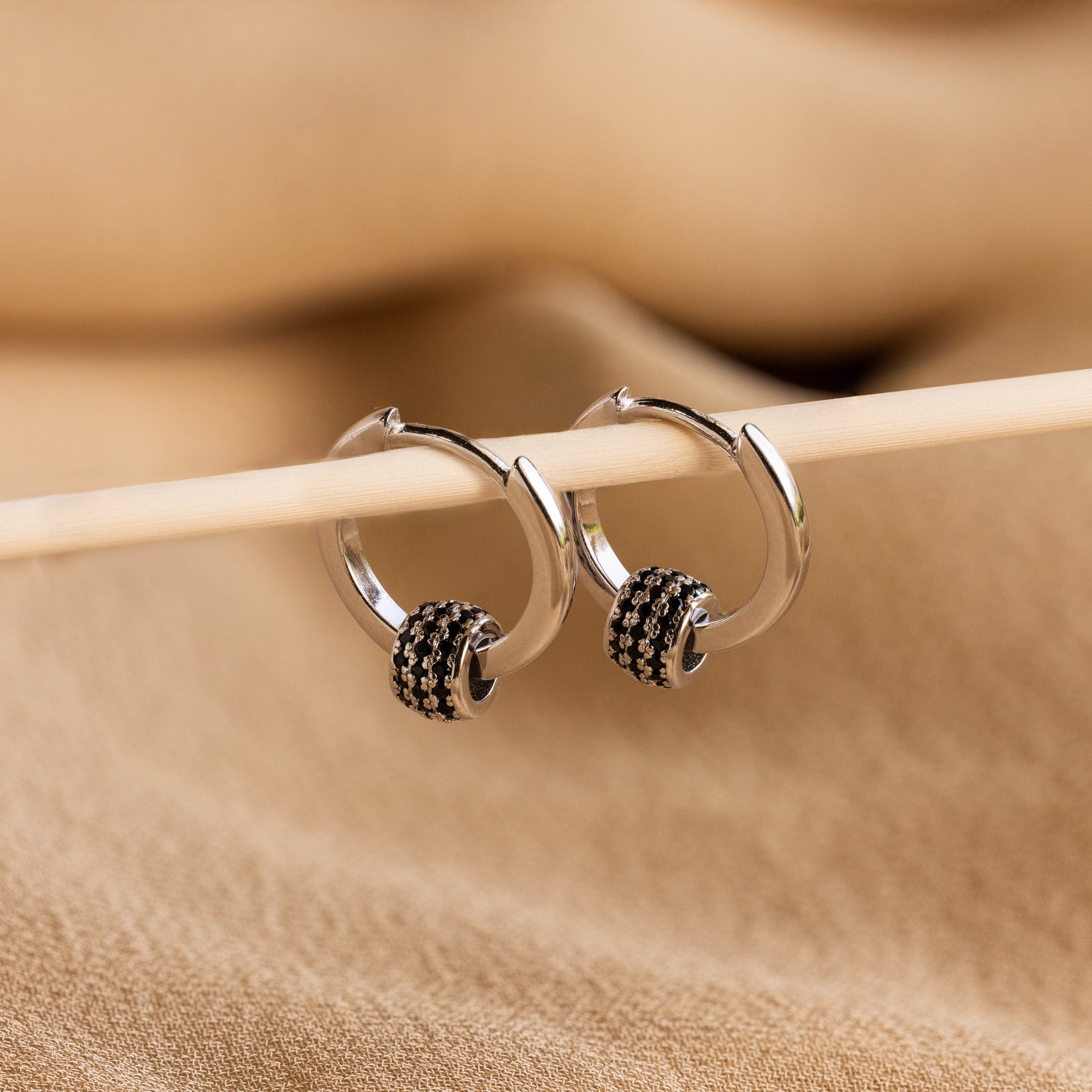 Onyx Pave Beaded Hoops are elegant huggie-style earrings, featuring sparkling black onyx pavé detailing.