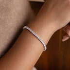 A close-up of a wrist wearing the 3 Prong Tennis Bracelet—a delicate, sparkling accessory that exudes timeless elegance.