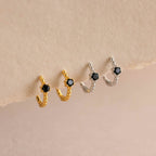 Two pairs of Onyx Beaded Huggies—one gold, one silver—each with a hexagonal Onyx charm for subtle elegance.