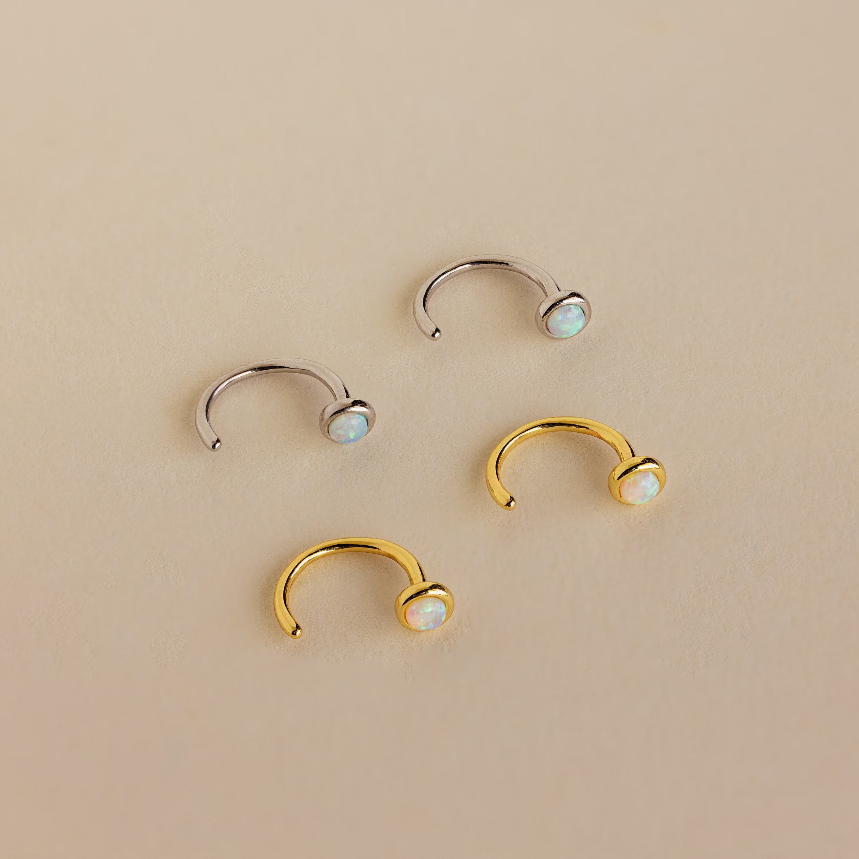 The Opal Threader Huggies are delicate earrings that add a subtle sparkle and celestial charm to any look.