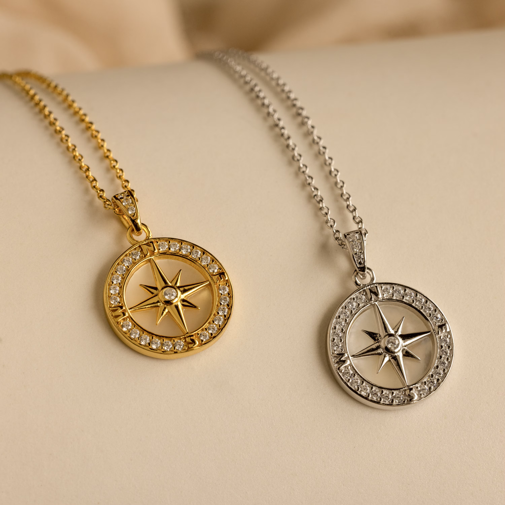 The Pave Pearl Compass Necklace features gold and silver compass rose pendants with crystals on matching chains—a stunning piece for any Nautical Jewelry collection or as a unique Mother of Pearl Necklace.