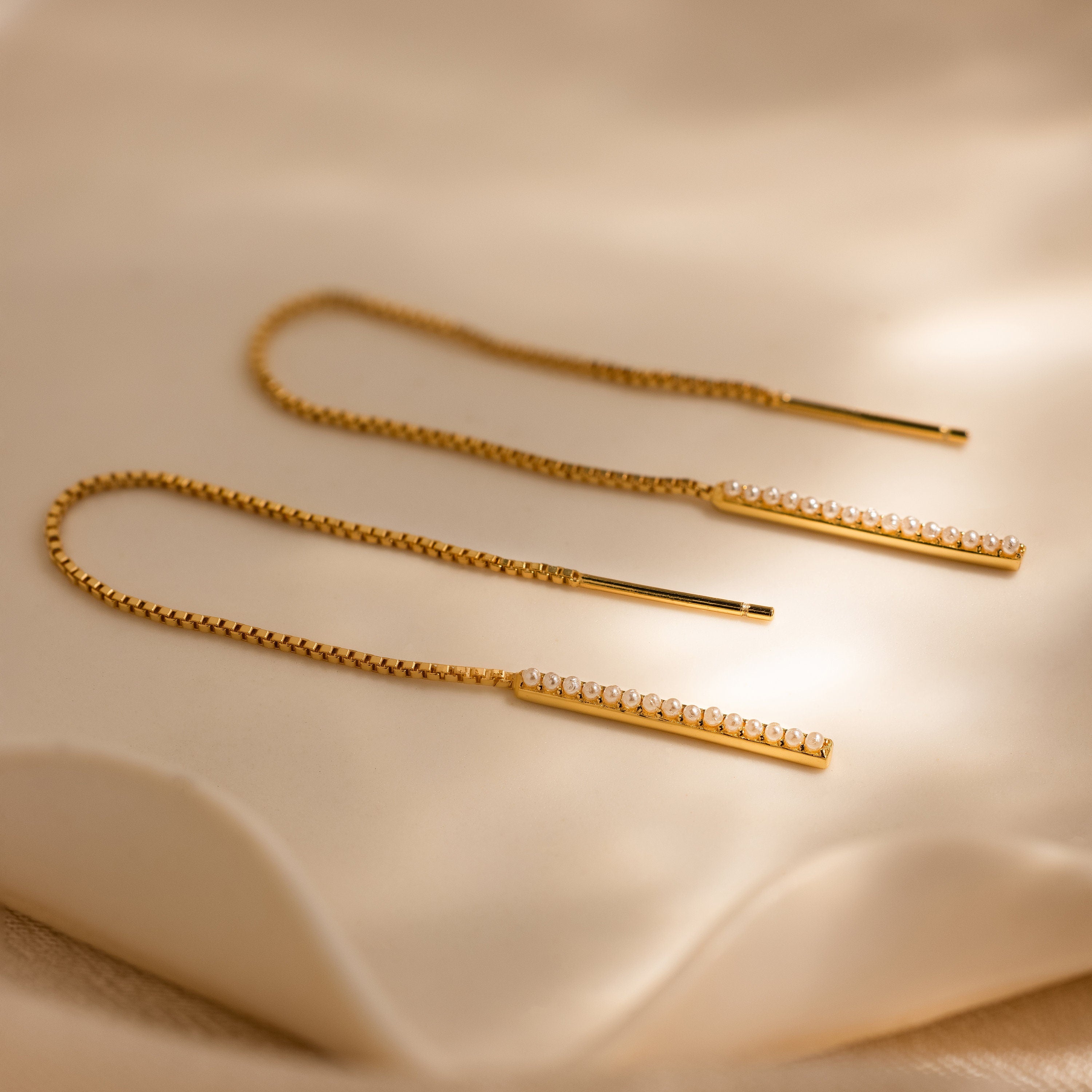 The Pearl Bar Threader Earrings pair beautifully with a gold diamond chain, creating a sophisticated, modern pearl jewelry look.