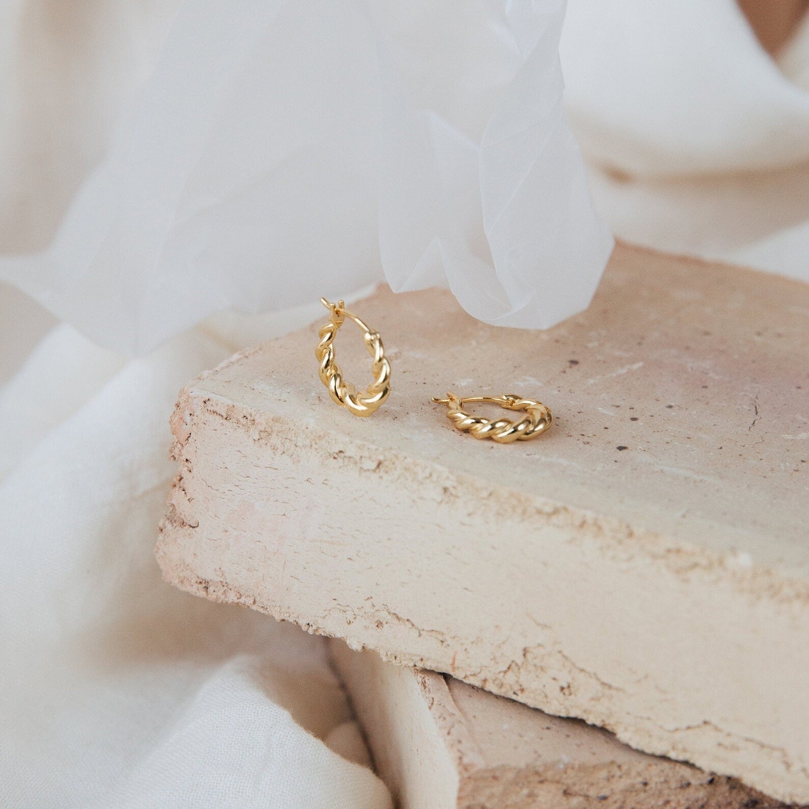 The Summer Statement Earrings Set is displayed on stacked beige bricks with a soft white fabric backdrop—perfect for making an elegant summer statement.