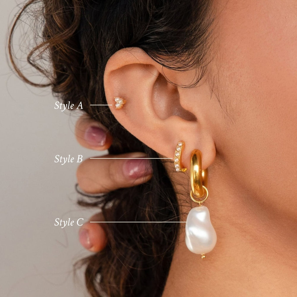 Close-up of an ear wearing three gold earrings from the Baroque Pearl Earrings Set, labeled Style A, B, and C. Style C features an elegant pearl drop.