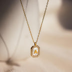 The Pave Pearl Initial Necklace features a gold pendant with the letter A, accented by sparkling stones—an elegant CZ diamond necklace that adds a brilliant touch.