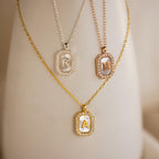 Three Pave Pearl Initial Necklaces, each with a gold or silver rectangular pendant featuring the letters R, H, and A, make a stunning CZ diamond necklace set.
