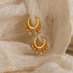 Chandelier Diamond Huggies showcased on textured cream-colored fabric.