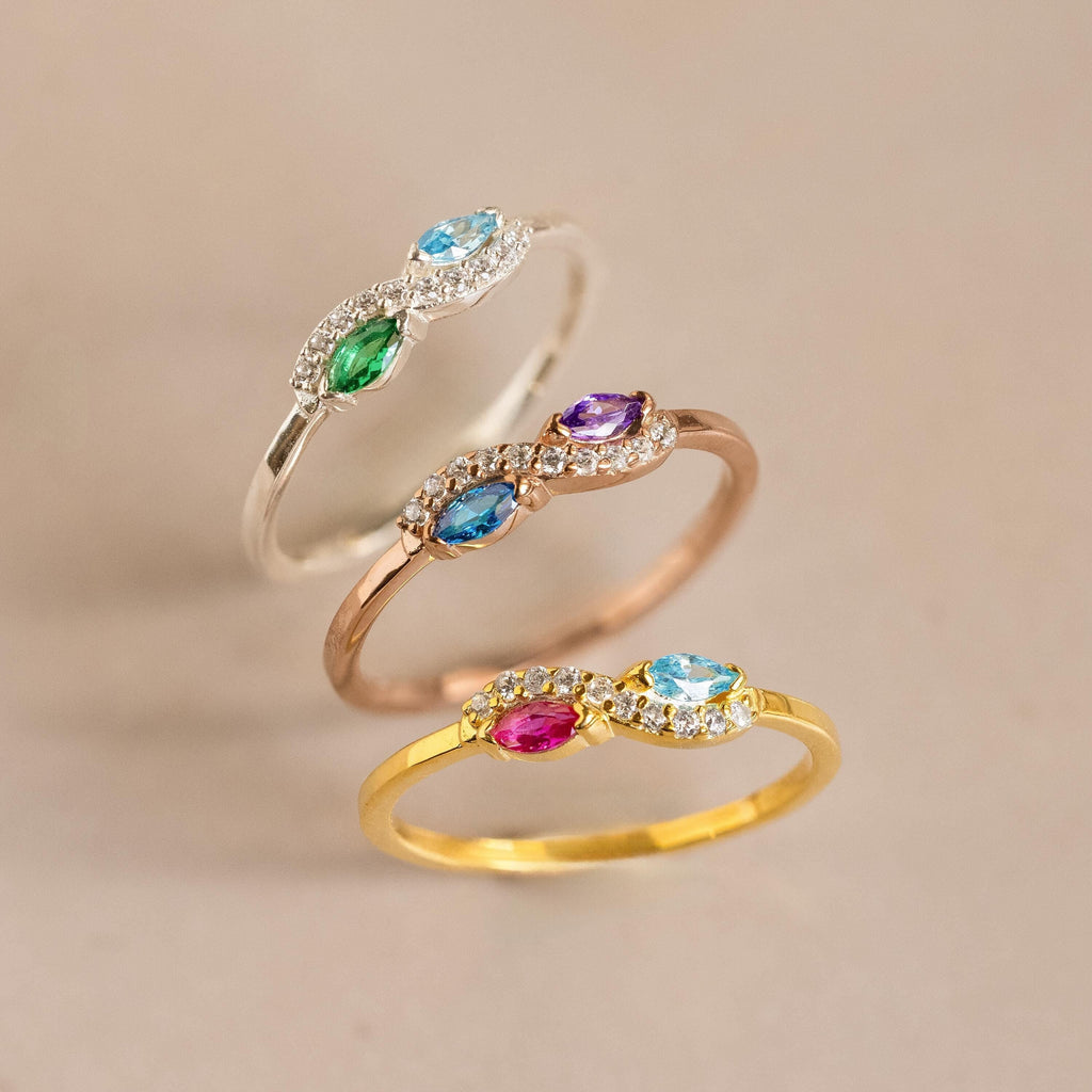 The Infinity Marquise Birthstone Ring features a colorful gemstone and diamonds in gold, rose gold, or silver—ideal for stacking or wearing solo. Add a touch of personalized elegance to your look with this stunning piece.