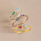 The Infinity Marquise Birthstone Ring features a colorful gemstone and diamonds in gold, rose gold, or silver—ideal for stacking or wearing solo. Add a touch of personalized elegance to your look with this stunning piece.
