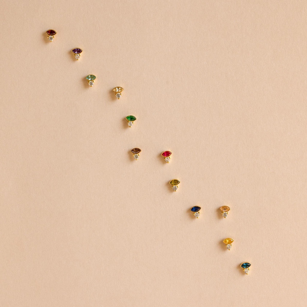 The Diamond Marquise Birthstone Studs feature a row of sparkling gemstones in an elegant marquise-cut design, perfect for adding shine to any outfit.