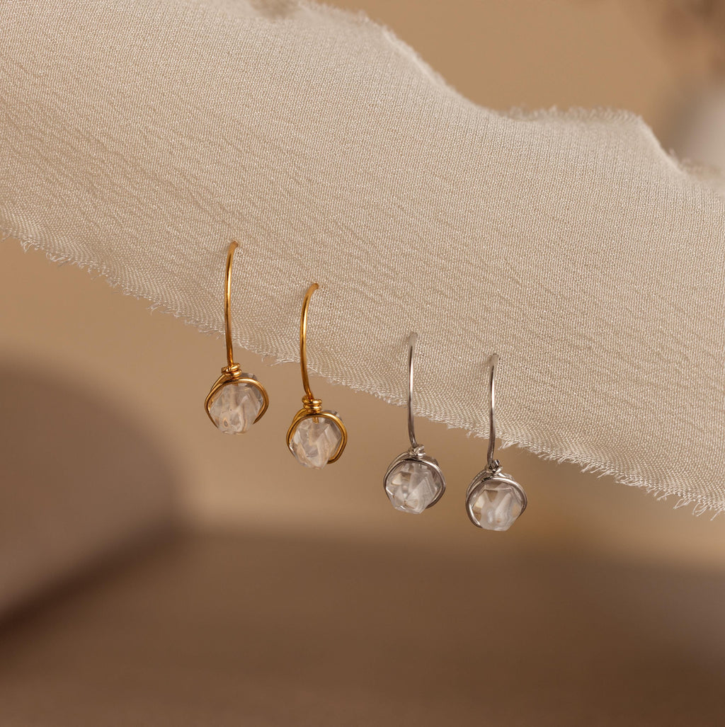 A row of Herkimer Diamond Threaders displayed on fabric, showcasing bohemian, nature-inspired jewelry designs.