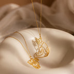 Two gold Custom Pet Line Art Necklaces featuring outline pendants of a dog and cat, displayed on a cream surface. Celebrate your furry friends in style with this personalized pet jewelry.