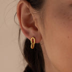 Close-up of a woman's ear wearing Link Drop Studs—small gold double link chain earrings, ideal for adding an elegant touch to any outfit.