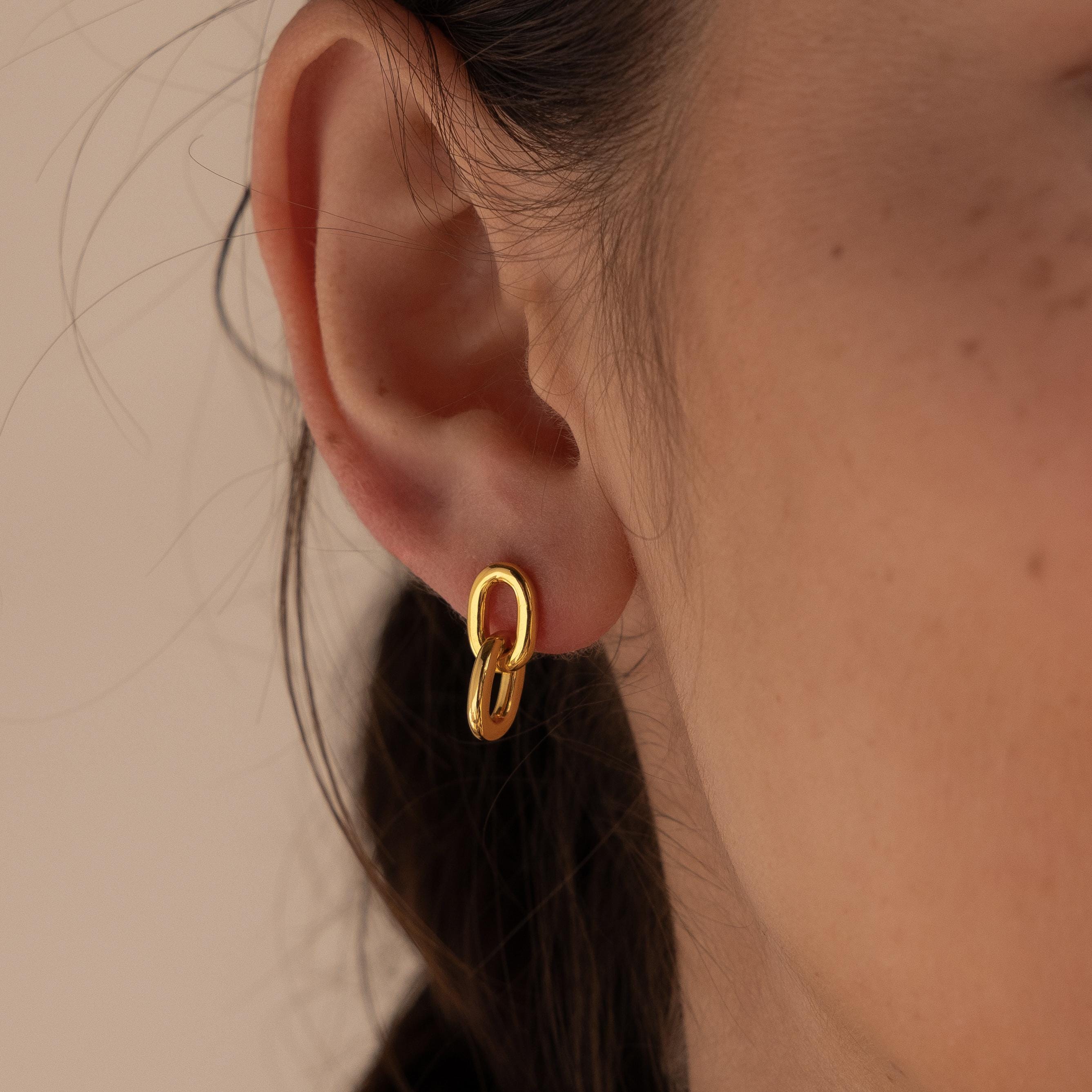 Close-up of a woman's ear wearing Link Drop Studs—small gold double link chain earrings, ideal for adding an elegant touch to any outfit.