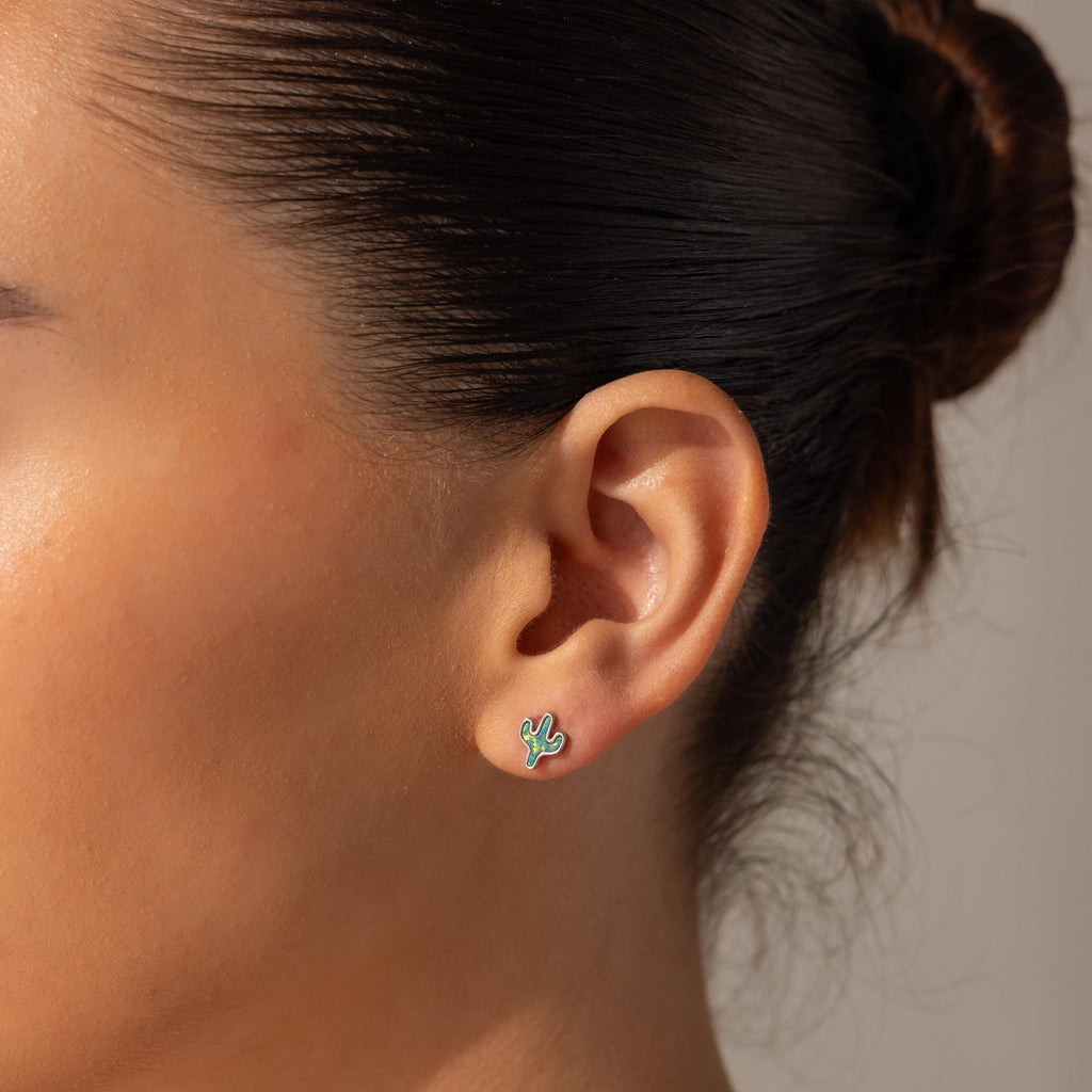 A woman with her hair in a bun wears Opal Cactus Studs, shown in a close-up of her ear.