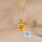 The Paw Print Coin Necklace features a round pendant engraved with a paw print—perfect as customizable pet jewelry or a pet memorial necklace.