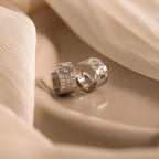 The Pave Checkered Huggies are silver diamond earrings that blend contemporary flair with timeless style.