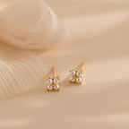 The Pearl Ivy Flower Studs feature gold settings with clusters of small white pearls arranged in a floral design—perfect for weddings or adding an elegant, floral touch to any outfit.