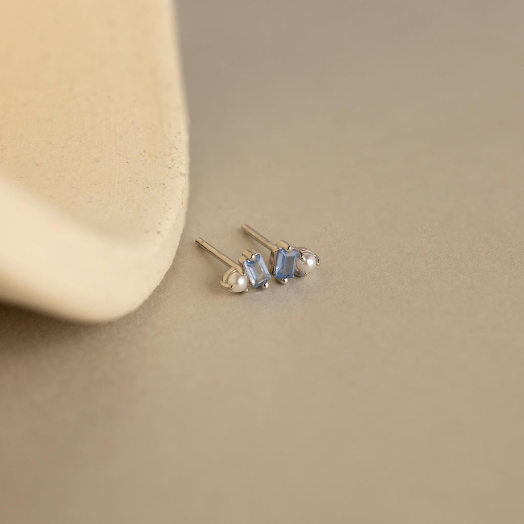 The Pearl Aquamarine Studs elegantly pair lustrous pearls with sparkling aquamarine accents for a refined, timeless look.