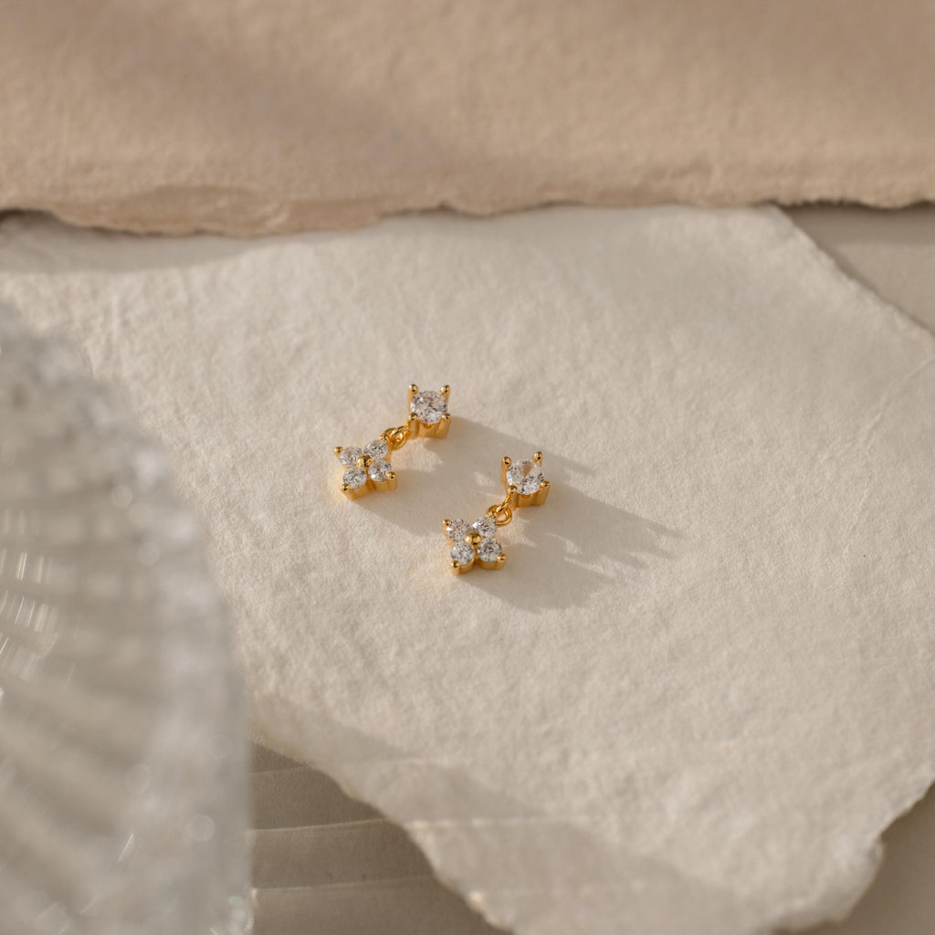 The Ivy Flower Flat Back Studs are displayed on textured cream paper in soft, natural light—an elegant gift idea for Mother’s Day.