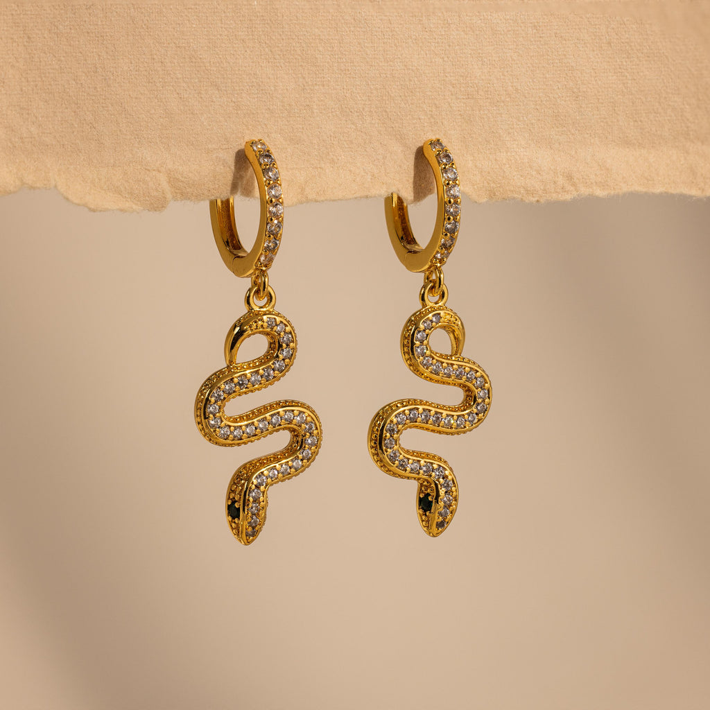 The Pave Snake Charm Hoops feature sparkling diamond accents in a stylish gold design, perfect for adding elegance to any outfit.