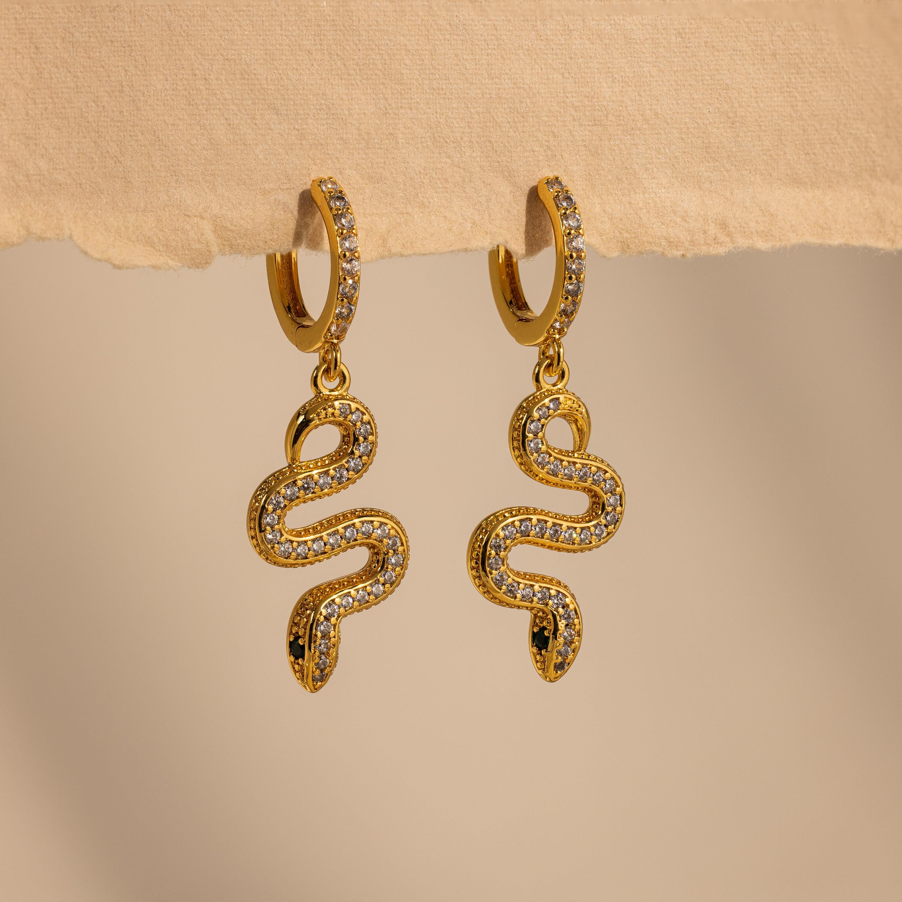 The Pave Snake Charm Hoops feature sparkling diamond accents in a stylish gold design, perfect for adding elegance to any outfit.