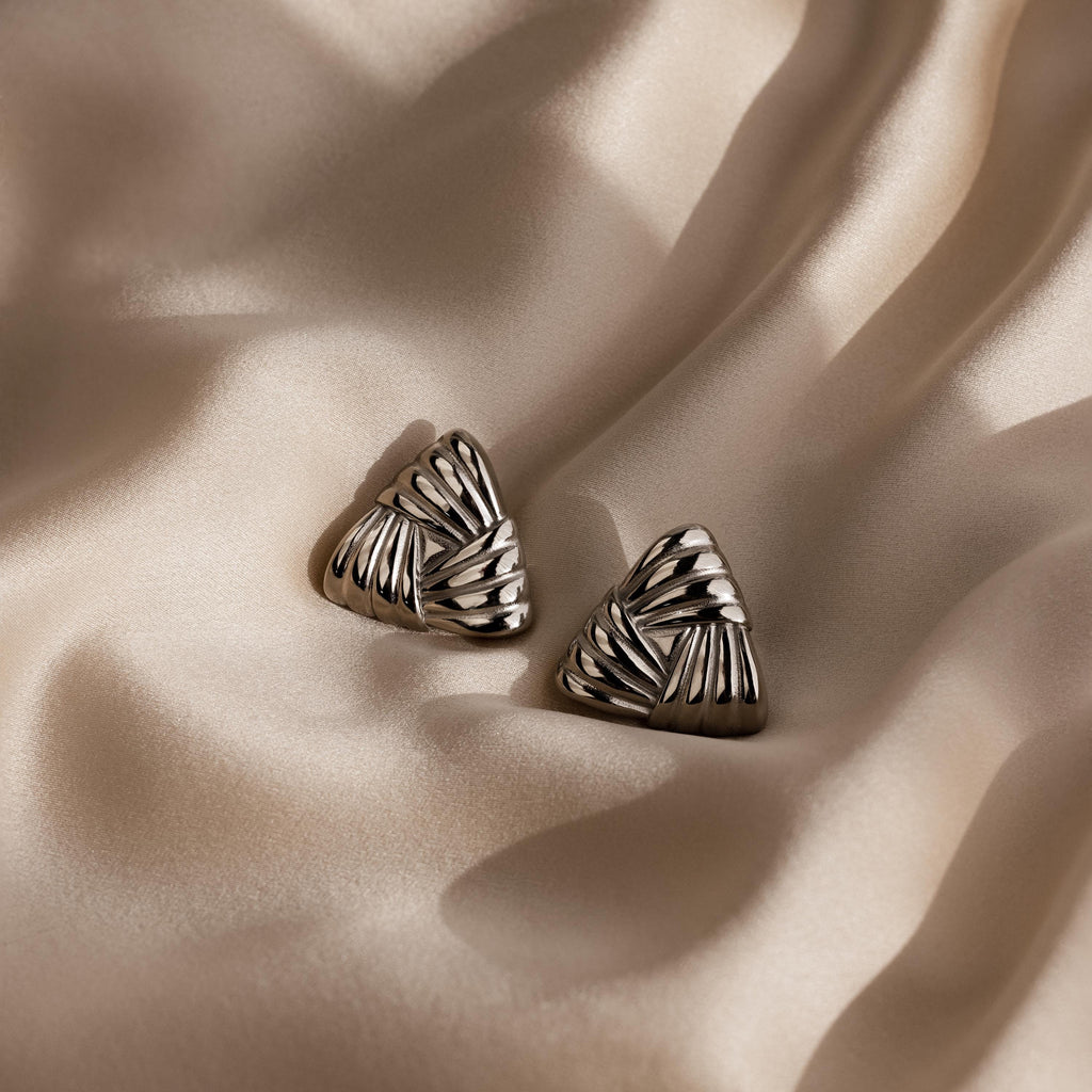 Bold Triangle Knot Studs with cut-out patterns make a striking statement accessory, perfect for adding flair to any outfit.