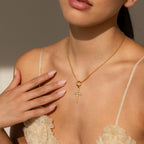 Model wears gold Rolo Necklace with a dangling gold Pave Cross Charm