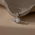 Silver Pave Evil Eye Charm. The design features a marquise diamond in the center with pave gemstones surrounding it in the shape of an eye.