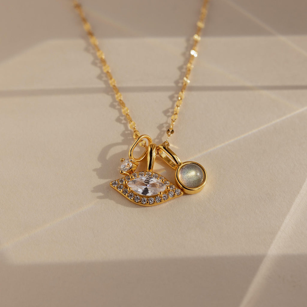 Gold Pave Evil Eye Charm on mirror chain, paired with a moonstone signet charm and diamond charm 