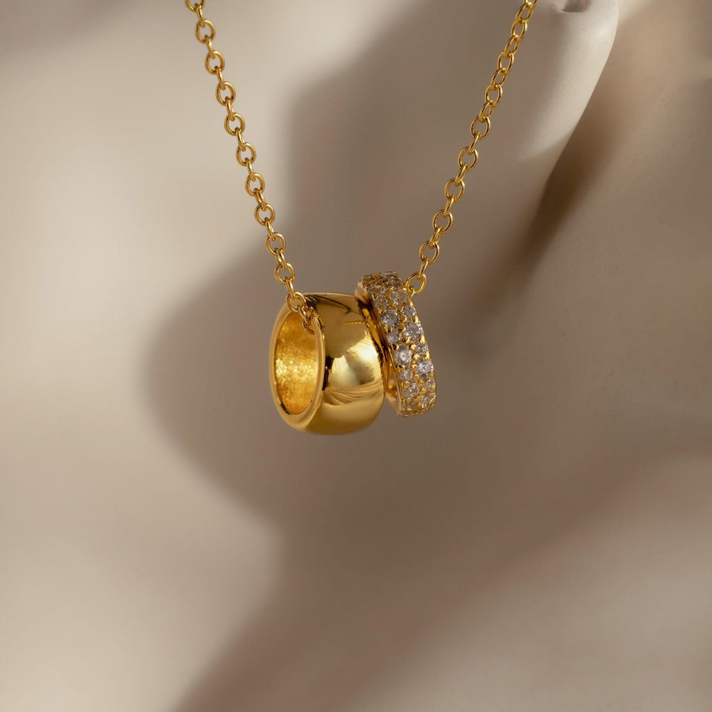 Elegant and dainty, the Pave Duo Circle Necklace features a gold chain with two gold rings—one plain, one embellished with pavé stones—for a sophisticated touch of charm.