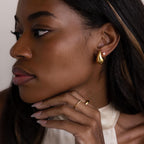 Woman with long hair wearing Chunky Tear Drop Studs and a sleeveless cream top.