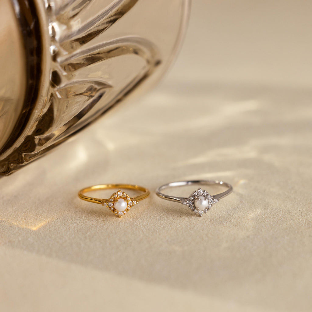 The Vintage Pave Pearl Ring in Sterling Silver, featuring a delicate central pearl, makes a perfect Christmas gift and is beautifully displayed on a light textured surface.