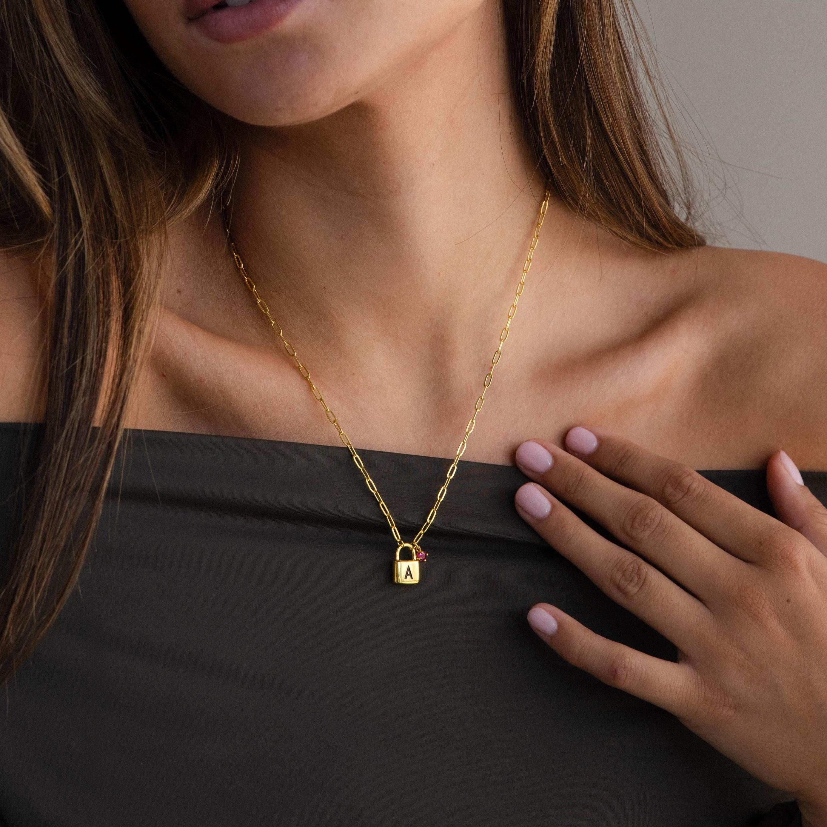 Woman wearing the Initial Birthstone Padlock Necklace, featuring a gold padlock pendant personalized with the engraved letter A.